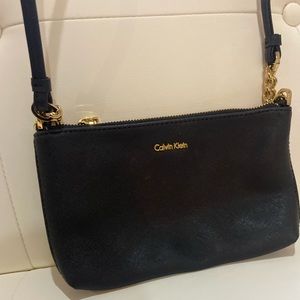 Calvin Klein black cross body bag gold accents zipper closure